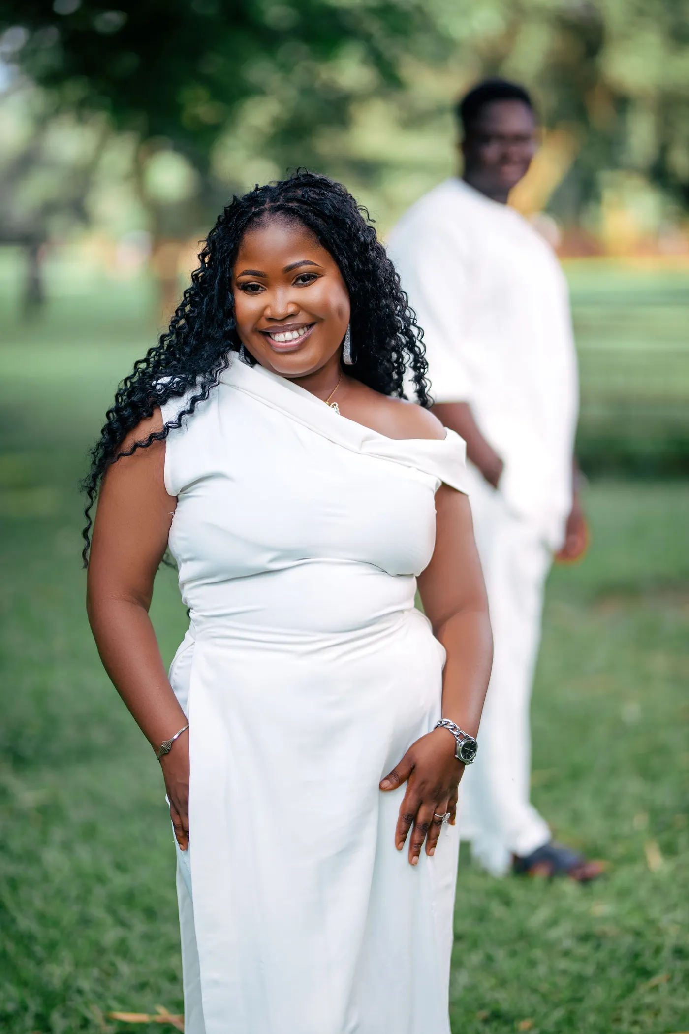Zubby in white, smiling, with Zicco behind her